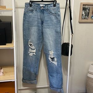 Distressed denim jeans with cuff at the bottom